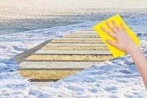 hand deletes spring snow by yellow cloth photo