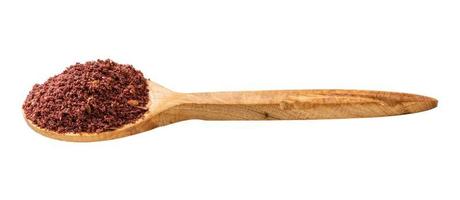 wooden spoon with ground sumac isolated photo
