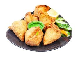 samosas fried savoury pastry on plate isolated photo