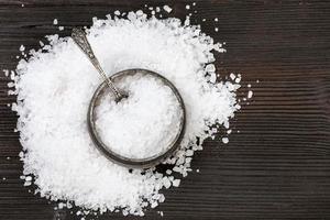 top view salt cellar with coarse Sea Salt on table photo