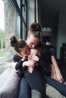 Mom and two daughters together at the window photo