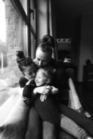 Mom and two daughters together at the window photo