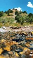 Frühlingsfluss fließt durch die Berge vor dem Hintergrund des blauen Himmels und der weißen Wolken video