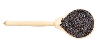 top view of raw black rice in wood spoon isolated photo