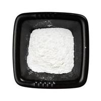 top view of baking powder in black bowl isolated photo