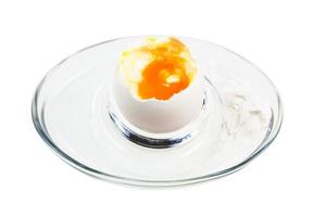 open boiled white egg in glass egg cup isolated photo