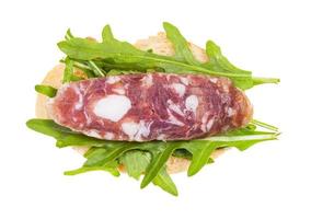 sandwich with bread, cured sausage and arugula photo