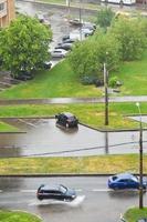 urban street with cars under pouring rain photo