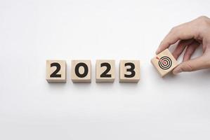 2023 goals. Holding a wooden block with goals 2023 on white background. year ,new life, new business, plan, goals, strategy,  concept, business vision, business growth photo