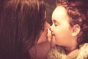 Loving mother and daughter face to face. photo