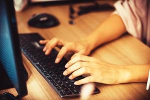 Close-up of entrepreneur typing on computer keyboard. photo