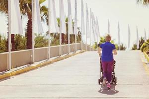 mom with baby stroller jogging photo