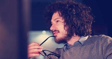 man working on computer in dark office photo