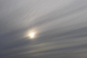 Dramatic blue sky and warm light clouds at sunrise time. photo