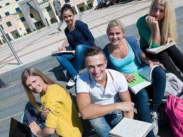 students outside sitting on steps photo