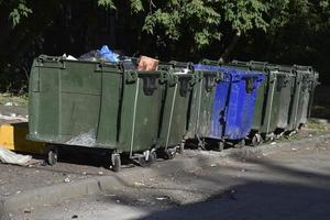 Garbage cans in the urban area and a landfill. Plastic garbage containers in the village. photo