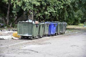 Garbage cans in the urban area and a landfill. Plastic garbage containers in the village. photo