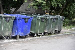 Garbage cans in the urban area and a landfill. Plastic garbage containers in the village. photo