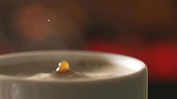 Falling drop into coffee cup, super slow motion. video