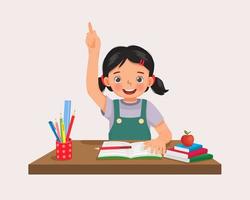 Cute little girl student rising hand answering question sitting at her desk in the classroom vector