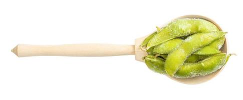 top view of frozen Edamame pods in wood spoon photo