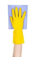 hand in yellow glove holds flat blue rag isolated photo