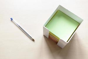 box with blank note papers and simple blue pen photo