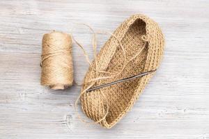 spool of hemp twine and hand-knitted bottom of bag photo