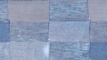 patchwork from many old blue denim flaps photo