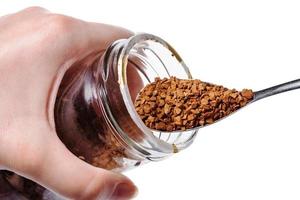 glass jar with instant coffee and spoon isolated photo