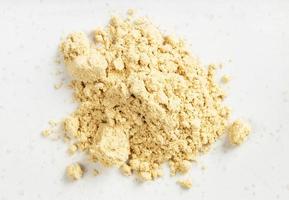 top view of pile of ginger powder close up on gray photo