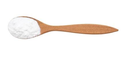 view of sodium bicarbonate in wood spoon isolated photo