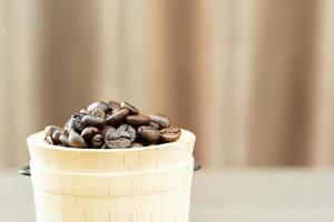 Close up Coffee beans in wood bucket photo