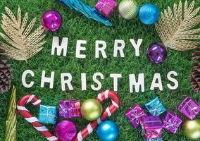 Christmas alphabet and decoration on green grass photo