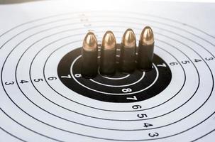 9mm pistol bullets on target shooting paper, soft and selectivec focus photo