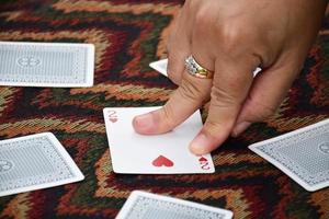 la jugadora de póquer está barajando póquer en sus manos antes de entregar las cartas de póquer a los otros jugadores de póquer, enfoque suave y selectivo en las cartas de póquer. foto