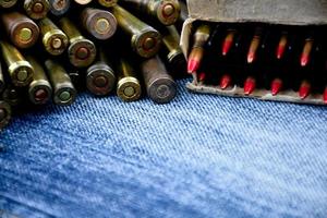 Closeup view of the old bullets on jeans floor, soft and selective focus on bullets, concept for collecting old bullets in free times. photo