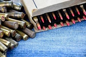 Closeup view of the old bullets on jeans floor, soft and selective focus on bullets, concept for collecting old bullets in free times. photo