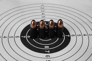 9mm pistol bullets on target shooting paper, soft and selectivec focus photo