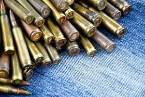 Closeup view of the old bullets on jeans floor, soft and selective focus on bullets, concept for collecting old bullets in free times. photo