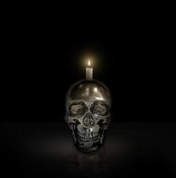 iron skull and candlelight on black background Halloween concept photo