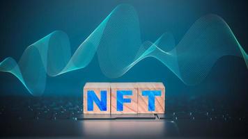 NFT word on wooden cube block which is placed on a laptop. NFT non fungible tokens concept. photo