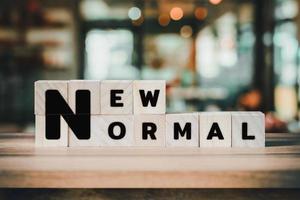 New Normal word on wooden cube block on wood table background. photo