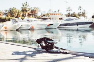 Mooring yacht rope tied around a cleat photo