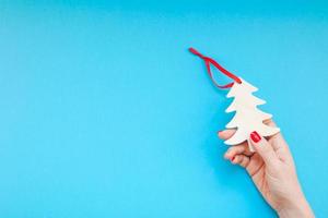 Woman hand holding homemade wooden christmas toy photo