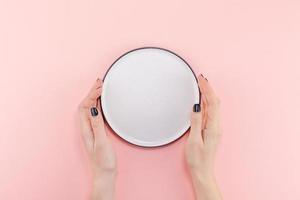 Empty plate in female hands mockup photo