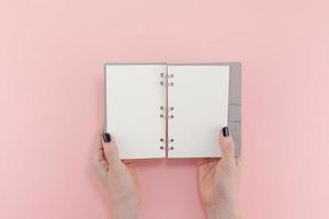 Woman hands with blank notepad mockup photo
