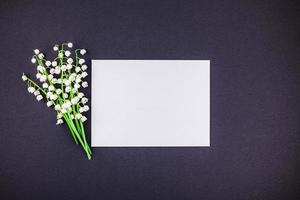 Frame mock up with bouquet of lilies of the valley photo