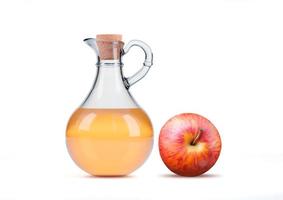 Transparent glass jug of organic apple cider vinegar isolated on white background. photo