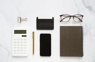 Flat lay of business branding mock up of workspace desk on white marble background, minimal template design photo